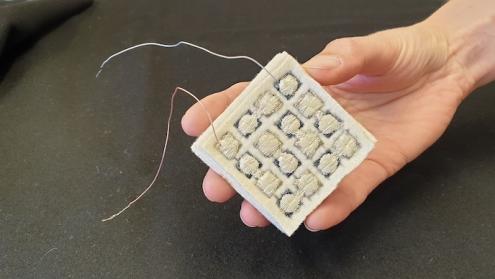 Cover image of Conductive fabric harvests body heat to drive wearable computers